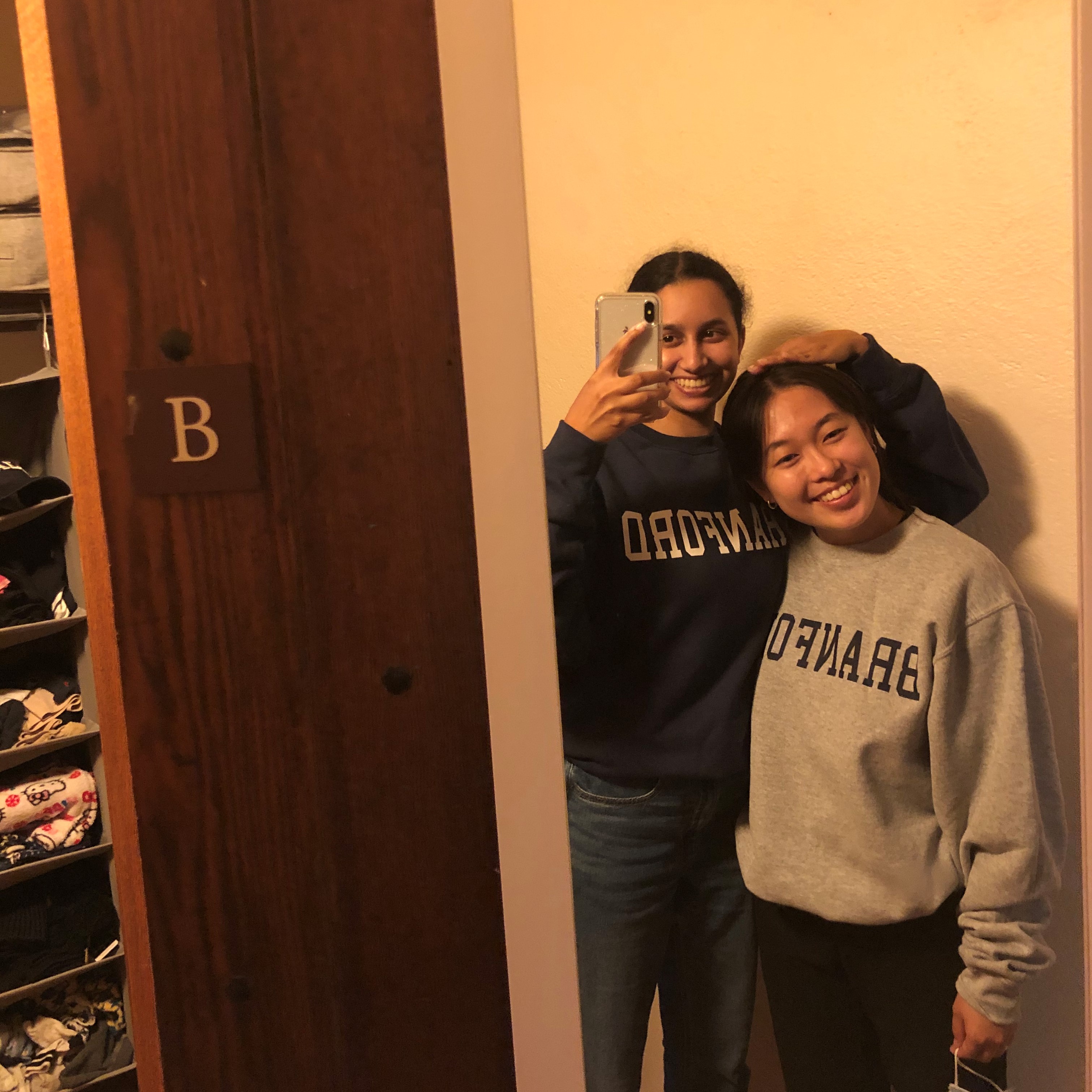 mirror selfie of priya and their roommate kelly in their dorm